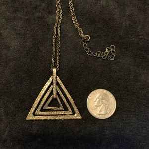 Antique gold (color) floating triangle necklace. Great Minimalist look.
